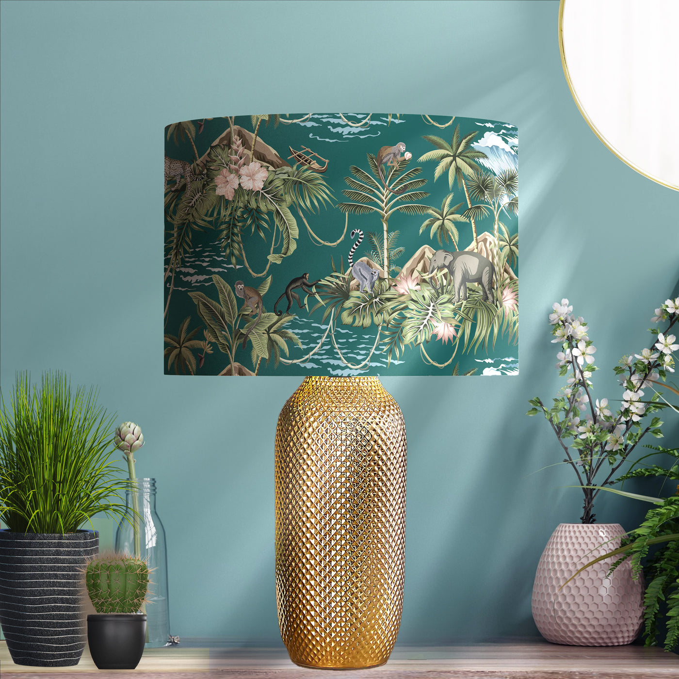 Green Lemur Island Cotton Lampshade with Mirror Copper Lining, pictured in living room setting on a gold lamp base