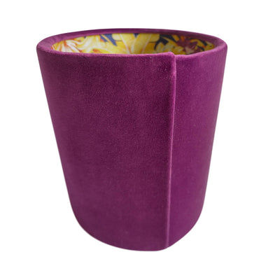 Oval lampshade in mulberry purple velvet with purple and gold tropical lining, pictured from the right hand side