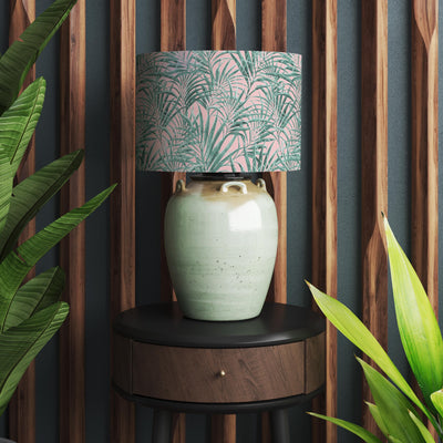 pink and green palm leaves lamp shade on table lamp