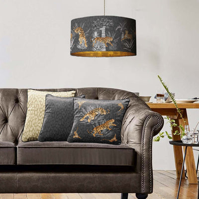 Vintage savanna lampshade in graphite grey with gold lining and matching cushion cover in living room setting