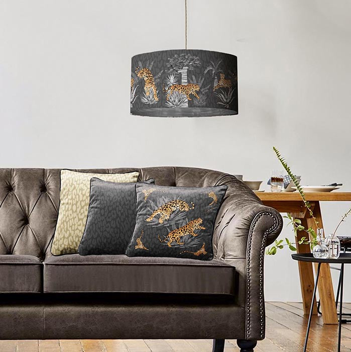 Vintage savanna lampshade in graphite grey with silver lining and matching cushion cover in living room setting
