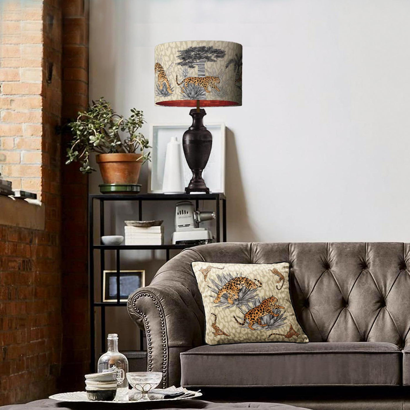 Vintage savanna lampshade in sandy beige with copper lining and matching cushion cover in living room setting