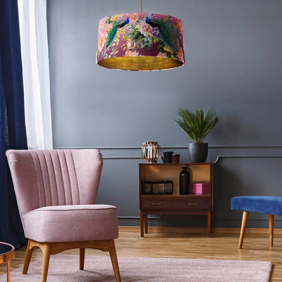 Pink Velvet Lampshade with Paradise Peacock and Mirror Gold Lining in living room above pink chair in front of dark grey living room wall